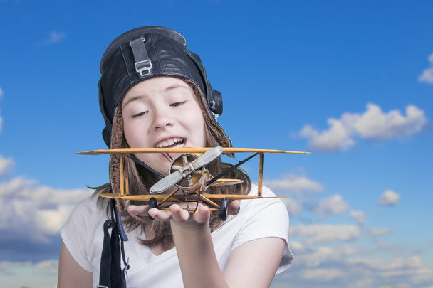 Cute young girl with airplane model - Photo, Image