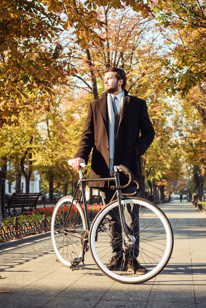 young caucasian businessman with bicycle - Photo, Image