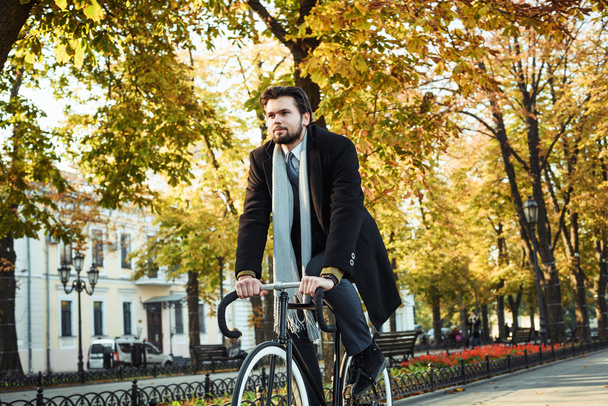 young caucasian businessman riding bicycle - Photo, Image