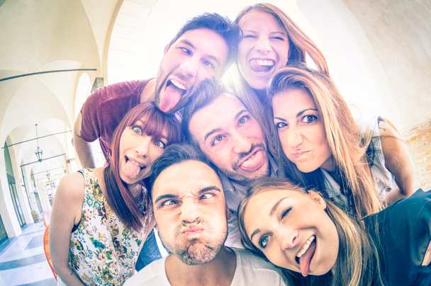 Beste vrienden nemen selfie buiten met achtergrondverlichting - Happy vriendschap concept met jongeren plezier samen - koude vintage gefilterde blik met zachte focus op gezichten te wijten aan zonneschijn halo flare - Foto, afbeelding