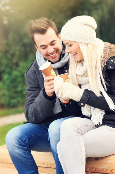Young couple drinking coffee outdoors - Foto, afbeelding