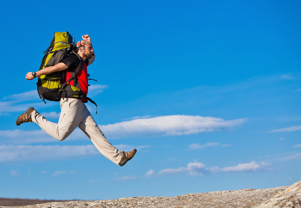 Hiker jumps on the rock - Foto, Imagem