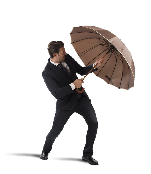 Businessman protect himself with umbrella - Foto, afbeelding