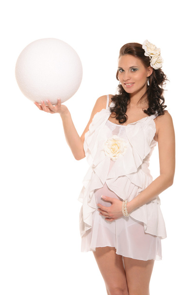 Pregnant woman holding white ball - Valokuva, kuva