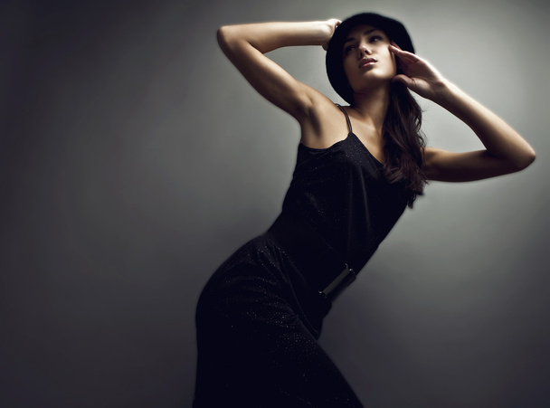 Beautiful woman on black classical dress pose in studio. - Фото, зображення