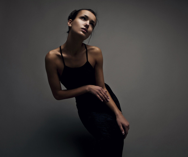 Beautiful woman on black classical dress pose in studio. - Foto, afbeelding