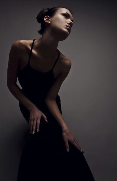 Beautiful woman on black classical dress pose in studio. - Valokuva, kuva