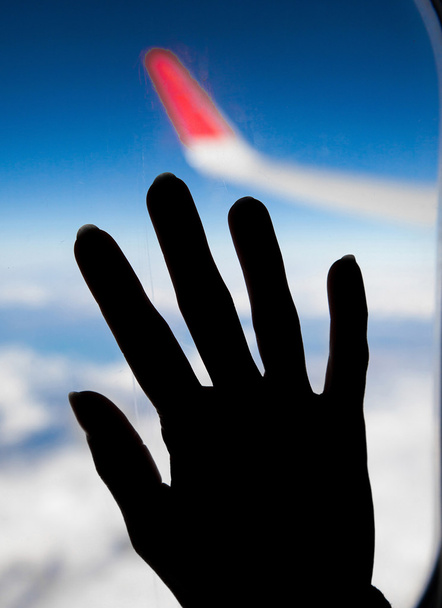 woman hand on a aeroplane window - Photo, Image