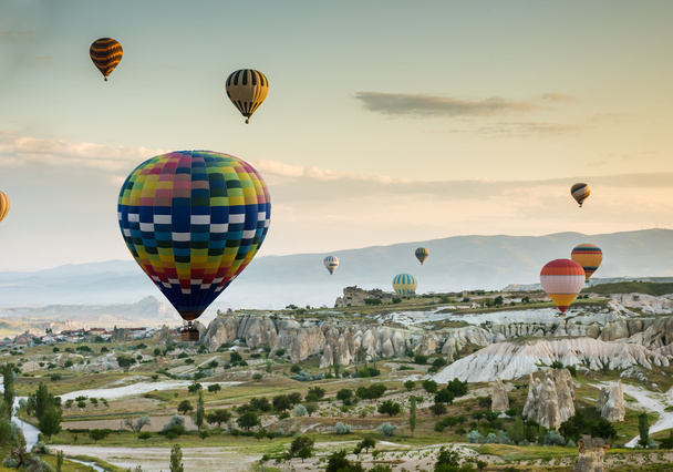 Hot air balloons fly over Cappadocia - Фото, изображение