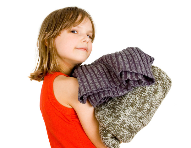 Little girl with stack of sweaters - Foto, immagini