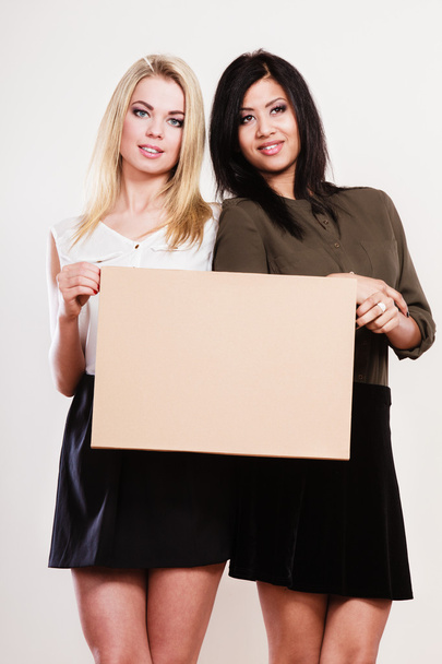 two women with blank board - Φωτογραφία, εικόνα