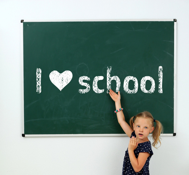 Cheerful girl at the blackboard. I love learning concept - Fotografie, Obrázek