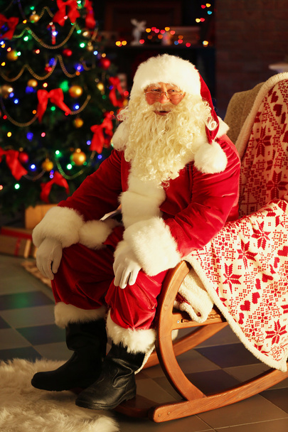 Santa Claus sitting in comfortable chair - Photo, Image