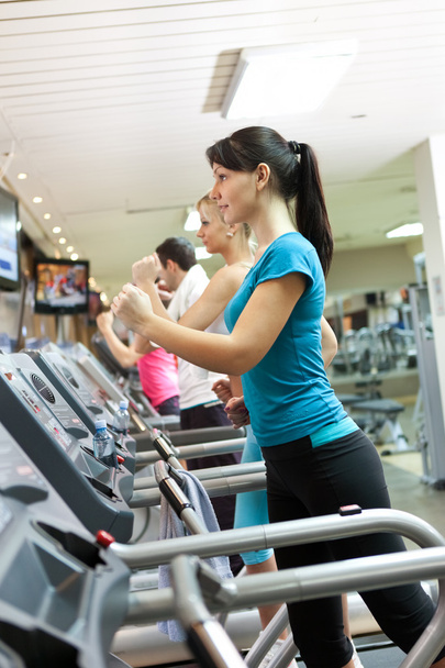 Young woman on treadmill - Foto, Imagen