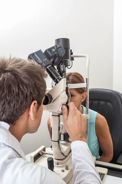 Ophthalmologist performing eye tests - Fotó, kép