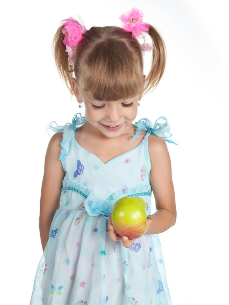 Pretty girl in a blue dress with an apple in her hand - Fotoğraf, Görsel