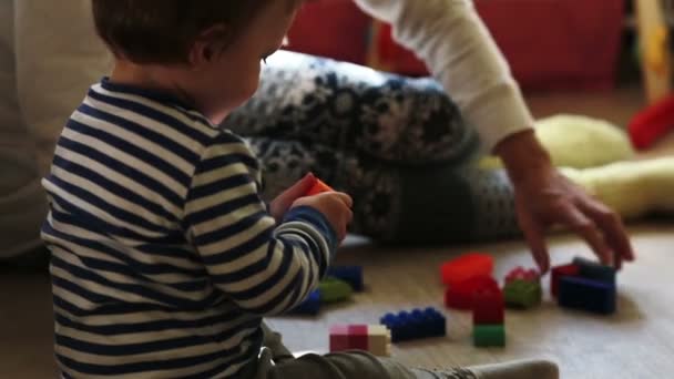 mother playing with her baby boy with toys - Séquence, vidéo