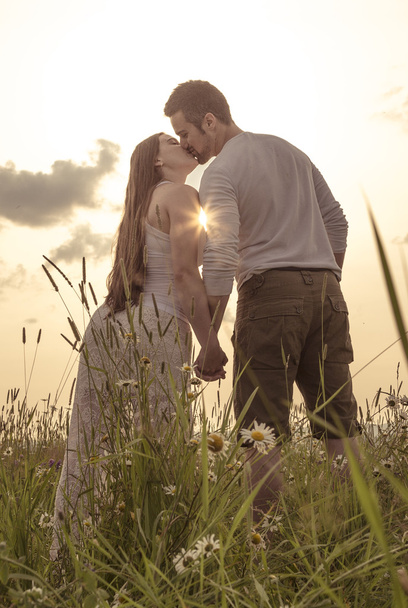 Young couple in love outdoor at the sunset - Fotografie, Obrázek