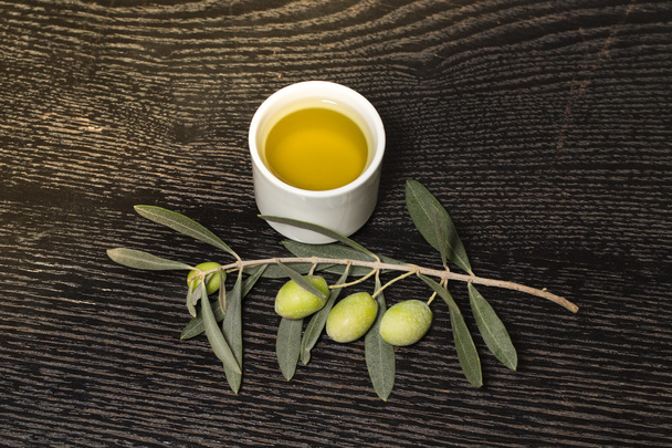 Branch of olive tree with green olive berries and cap of fresh o - Fotó, kép