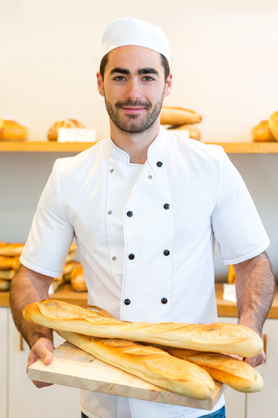 Young attarctive baker working at the bakery - Foto, Imagem