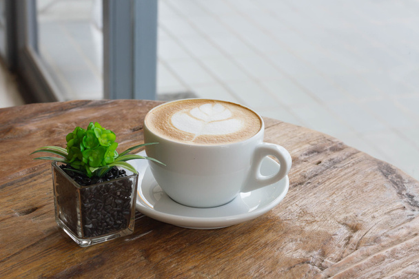 hot milk art coffee on wooden table - Foto, imagen