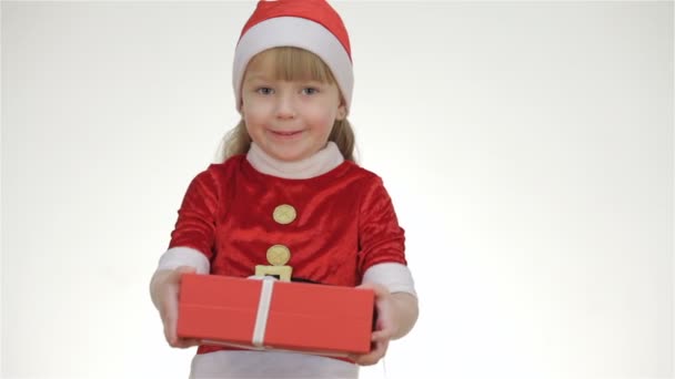 Kid girl offering a gift in a red box - Imágenes, Vídeo