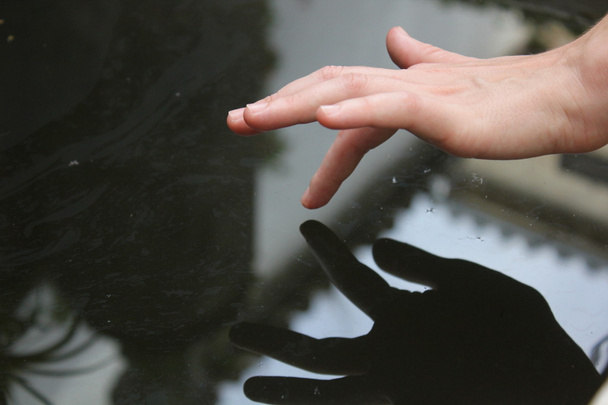 Hand touching the water - Photo, image