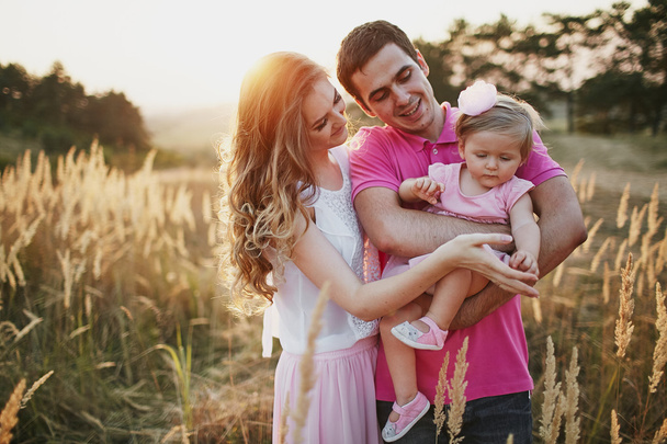 beautiful family of three people, mom dad and daughter - 写真・画像