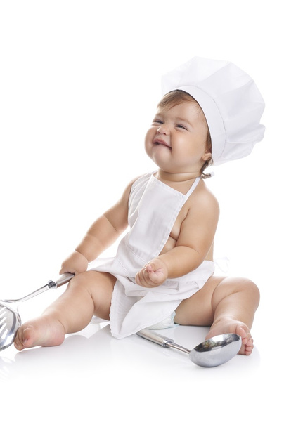 Funny adorable baby boy chef sitting and playing with kitchen equipment - Foto, immagini