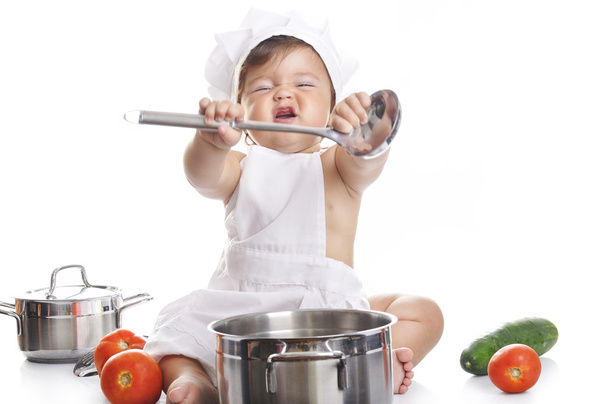 Funny adorable baby boy chef sitting and playing with kitchen equipment - Фото, зображення