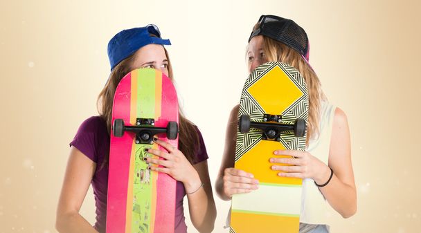 Ragazze nascoste dietro i loro skateboard
 - Foto, immagini