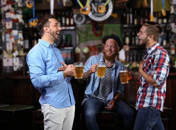 Young men in bar - Фото, изображение