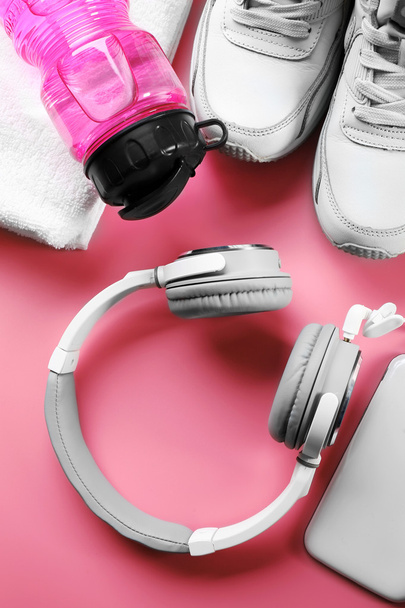 Headphones and sport equipment on pink background - Fotografie, Obrázek