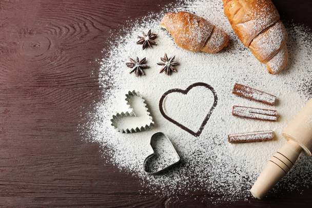 Heart of flour, croissant and spices on gray background - Foto, imagen