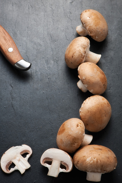 Sliced  and  whole  Mushrooms on rustic background - Photo, image