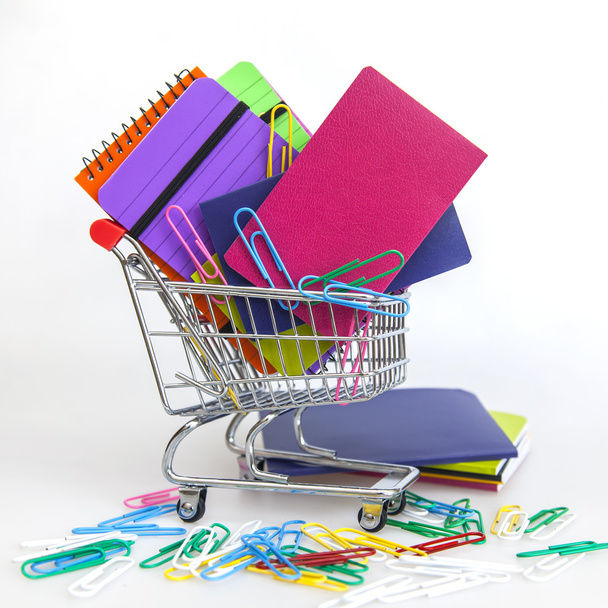 Notebooks of various colors in the cart for shopping - 写真・画像