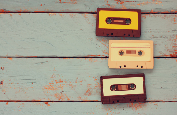 close up photo of vintage cassette tape over aqua wooden table . top view. retro filtered. - Photo, image