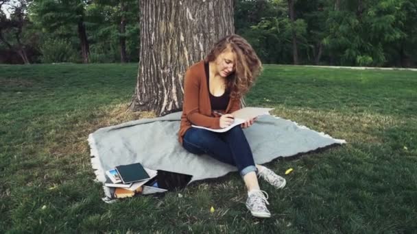 female student with a notebook in park slow motion - Footage, Video