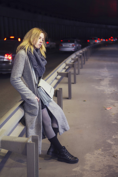 Beautiful blonde woman in long grey warm coat, skirt, boots and - Foto, Imagen