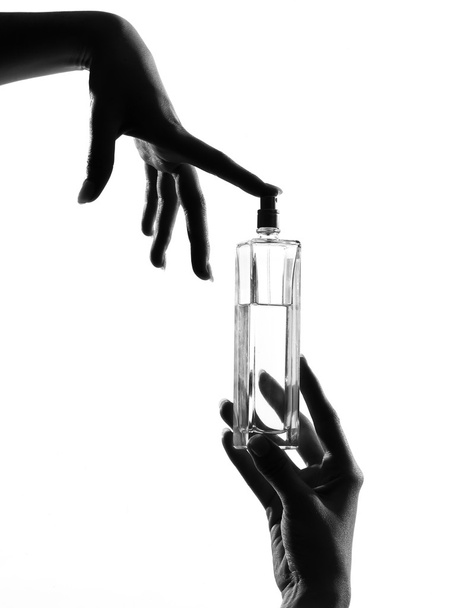 Detail close-up silhouette woman hands with perfume - Photo, image