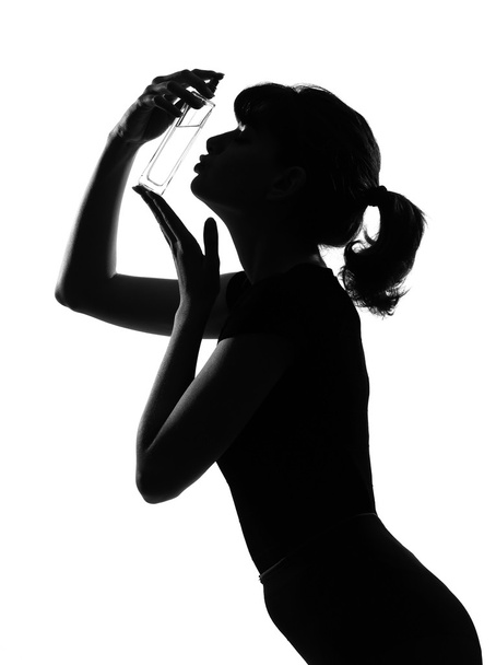Silhouette woman kissing her perfume - Foto, Imagem