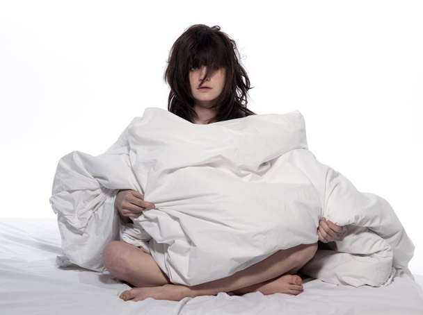 Young woman in bed awakening tired insomnia hangover - Фото, зображення