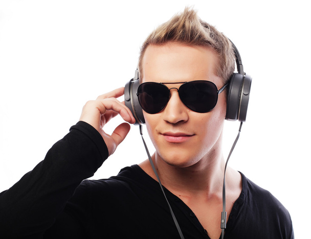 Happy young man listening to music with headphones - Zdjęcie, obraz