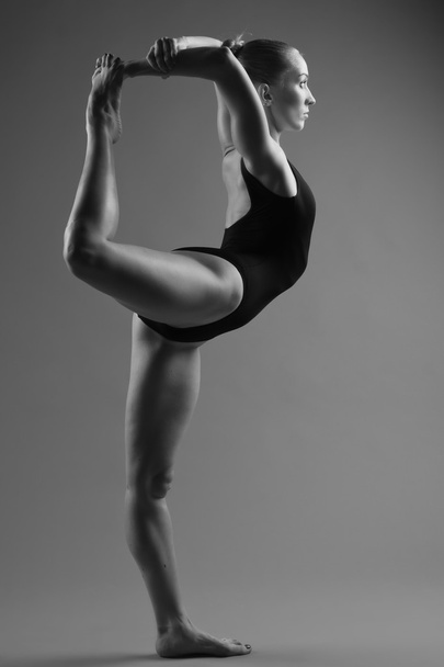Modern ballet dancer posing on dark background - Foto, Imagen