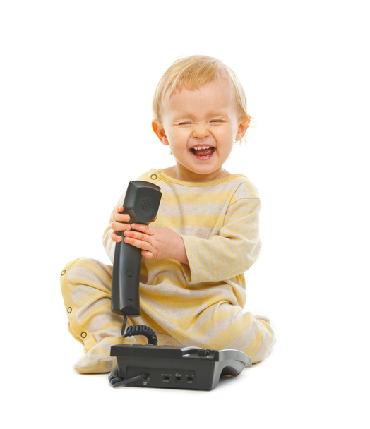 Laughing baby playing with phone isolated on white - Valokuva, kuva