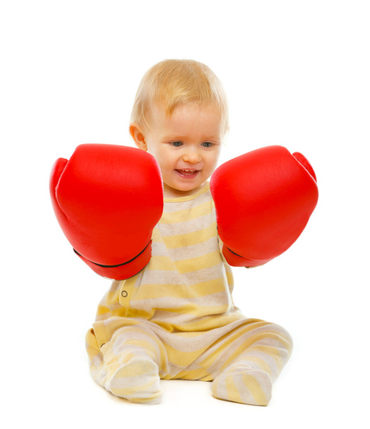 Cute baby in boxing gloves sitting on floor isolated on white - Фото, зображення