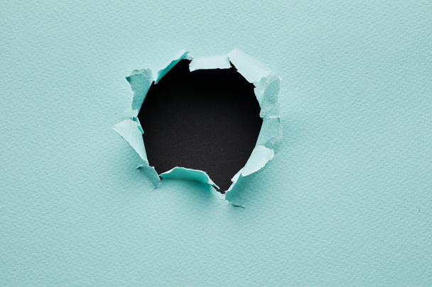Hole in the blue paper - Foto, Bild
