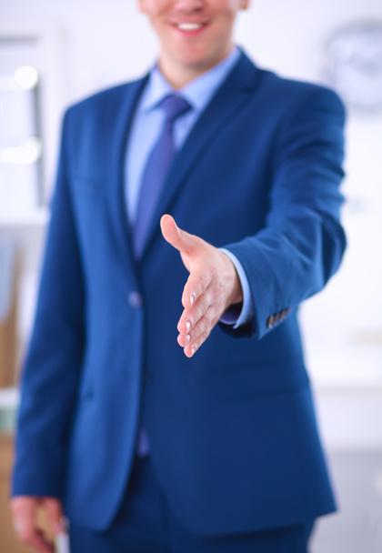 Business and office concept - handsome businessman with open hand ready for handshake - Photo, Image