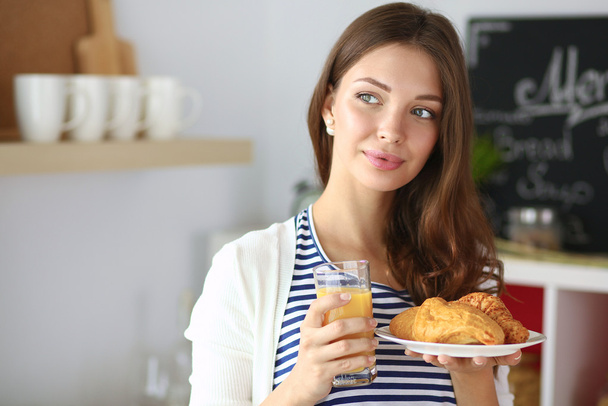 Young woman with glass of juice and cakes - Fotografie, Obrázek