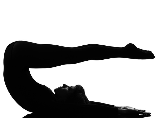 Woman halasana Shoulder Stand yoga pose - 写真・画像
